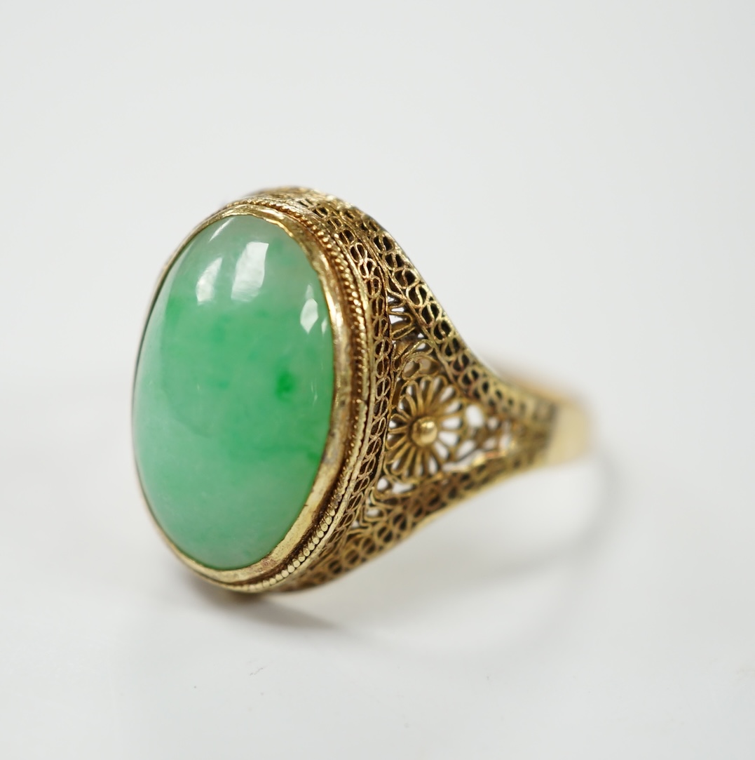 A Chinese 18k and cabochon jade set ring, size O, gross weight 3.9 grams. Condition - poor